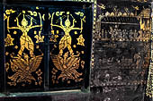 Wat Xieng Thong temple in Luang Prabang, Laos. Detail of the  intricate gold stencilling on black lacquer that decorate the walls of the sim. 